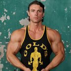 Man wearing a black tank top with yellow text and graphics against a textured green background