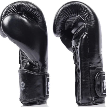 Pair of black fairtex boxing gloves on a white background