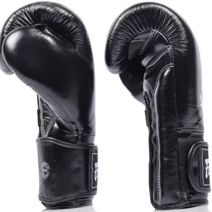 Pair of black fairtex boxing gloves on a white background