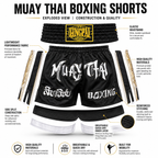 An exploded informational graphic showing black Muay Thai boxing shorts with white lettering, plus separate callout labels for waistband, side split, stitching, inner layer, and materials. The image includes feature text and icons, but the main subject is still the product itself rather than a pure instruction diagram.