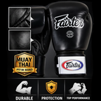 Black boxing glove with Fairtex branding on a dark background