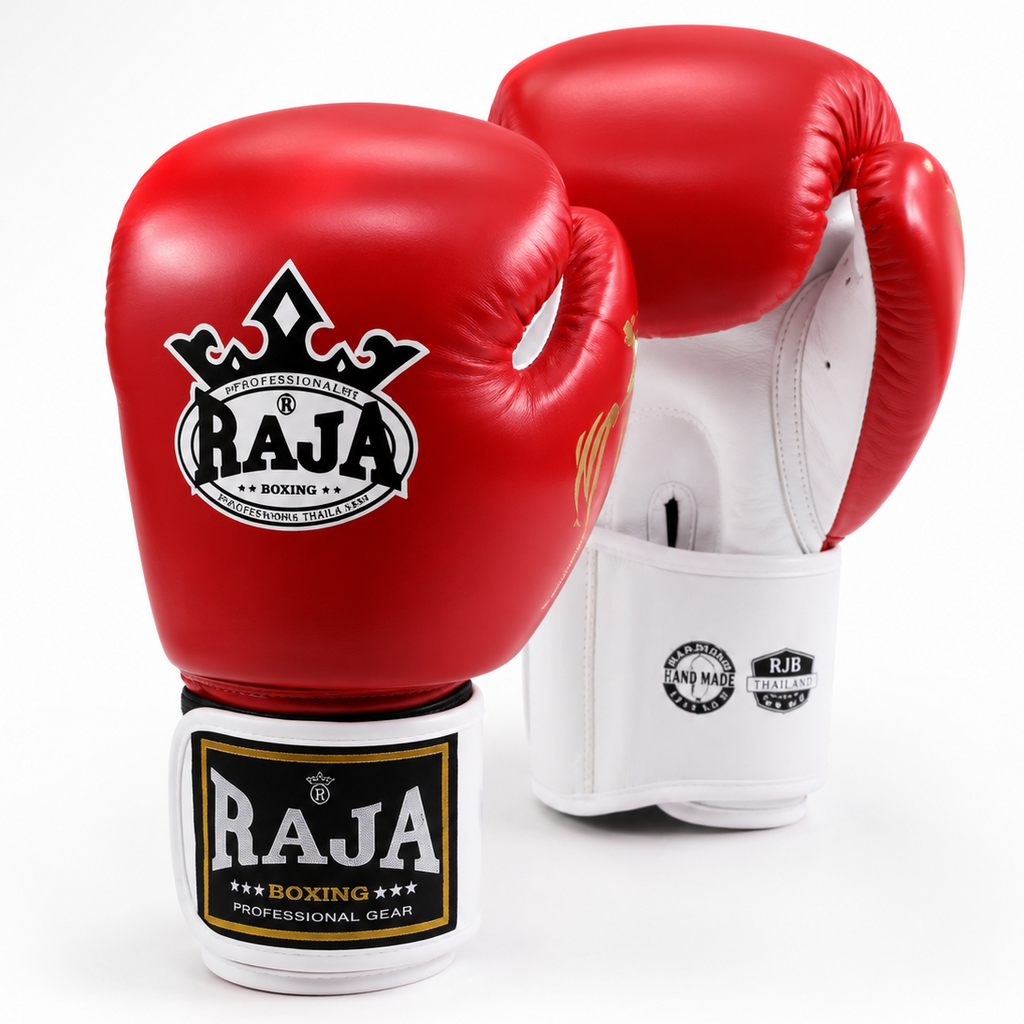 A pair of red boxing gloves with white interiors and white hand wraps featuring the black and gold RAJA Boxing logo, photographed on a clean white background.