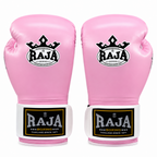 A pair of pink boxing gloves with white and black wrist straps and a black crown logo featuring the brand name 'RAJA'.