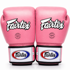 Pair of pink Fairtex boxing gloves on a white background