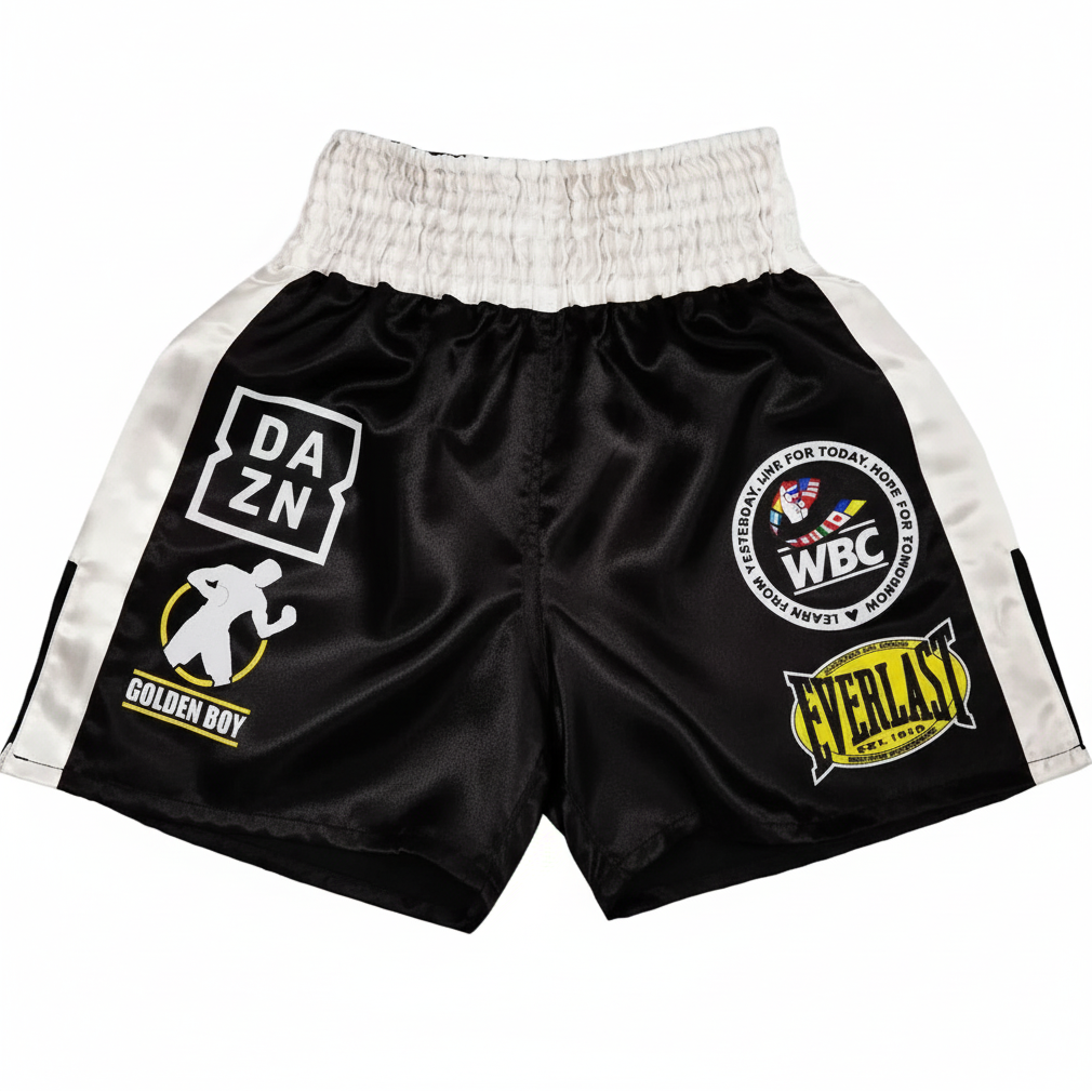 Black boxing shorts with various logos on a white background
