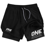 Black athletic shorts with white 'ONE Championship' logos on the left and right legs, featuring a white drawstring, shown against a plain white background.