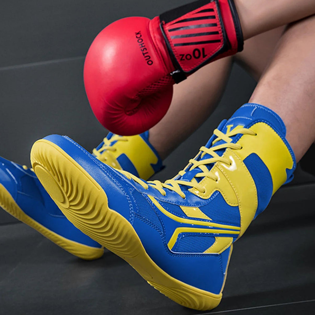 Person wearing blue and yellow boxing shoes with red boxing gloves on a dark background
