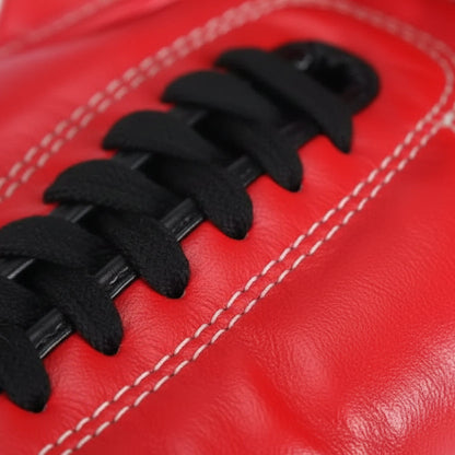 Pair of red boxing gloves with black accents on a white background 