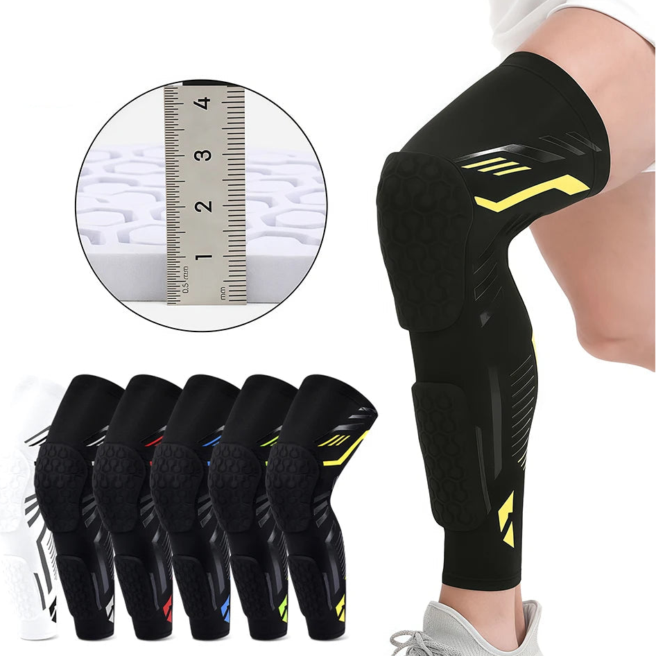 Black knee brace with yellow accents on a person's leg, accompanied by a ruler inset for size reference.