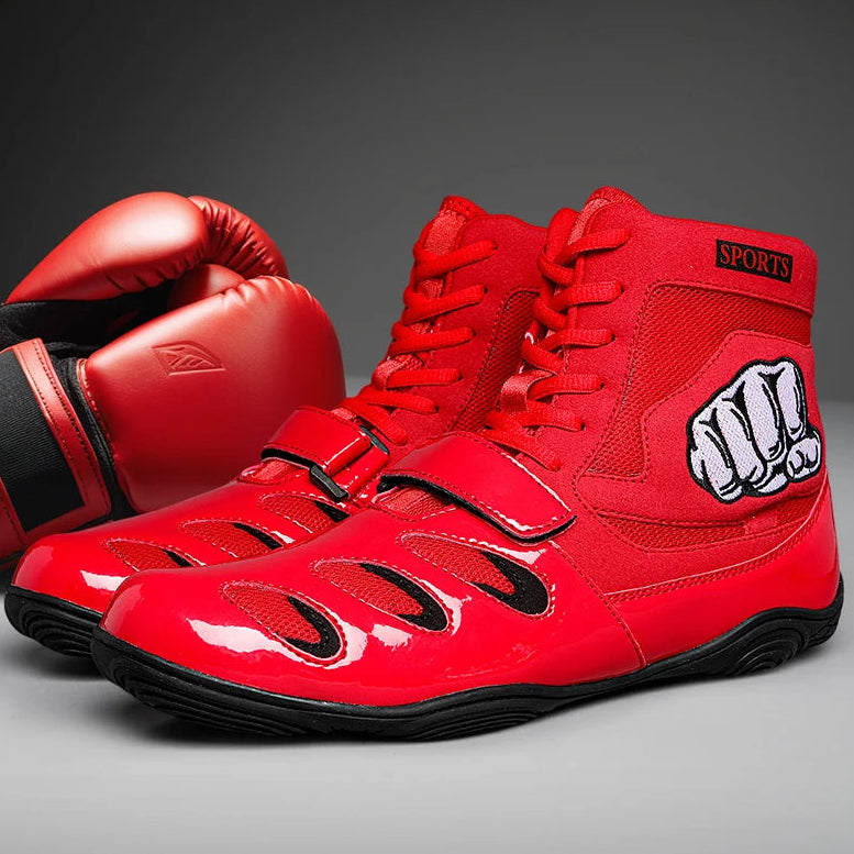 Red boxing shoes with a fist design on a gray background