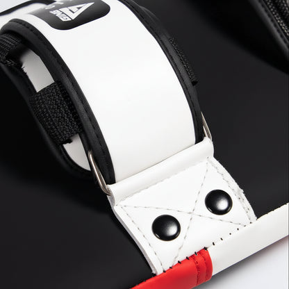 Close-up of a black and white glove with red accents on a gray background