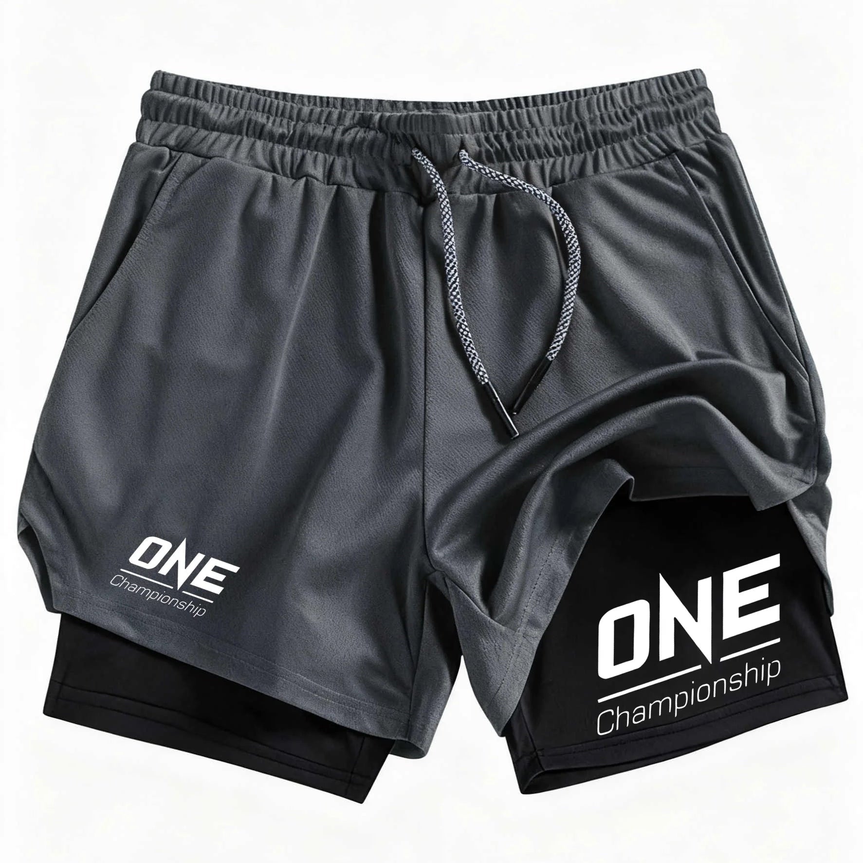 Black athletic shorts with a white 'ONE Championship' logo on the left leg and a larger version on the right leg, featuring a black inner layer and a gray drawstring.