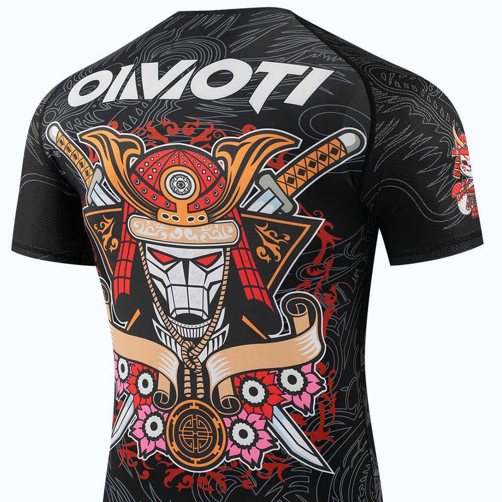 Black short-sleeve rash guard with a large Japanese samurai graphic on the back, featuring red, gold, white, and pink details, with the OIMOTI brand logo printed on the upper back and shown in the top left corner.