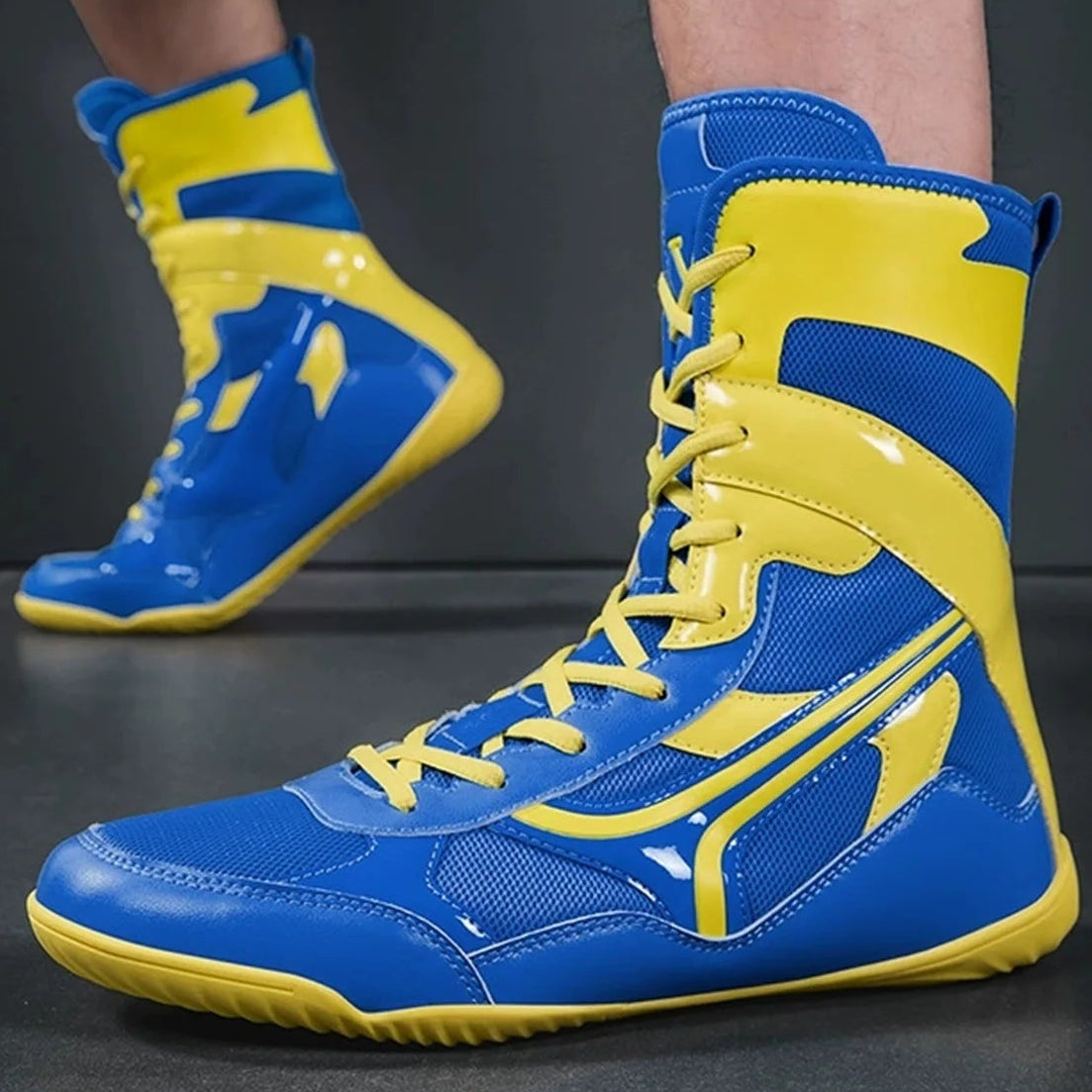 Blue and yellow boxing shoes on a dark background