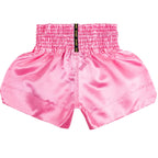 Pink athletic shorts with a visible brand logo on a white background