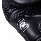 Black leather glove with a brand label on a white background