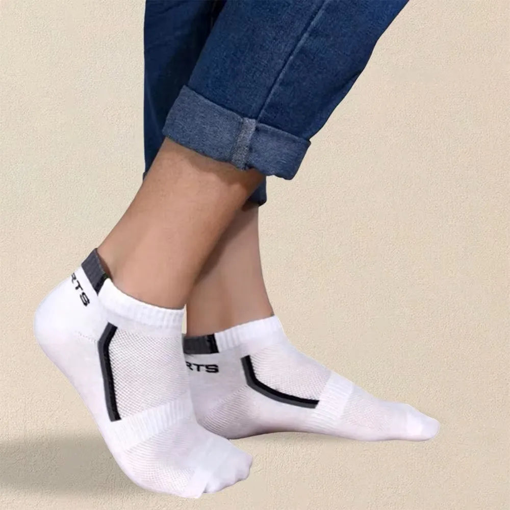 White socks with black logo worn by a person on a beige background