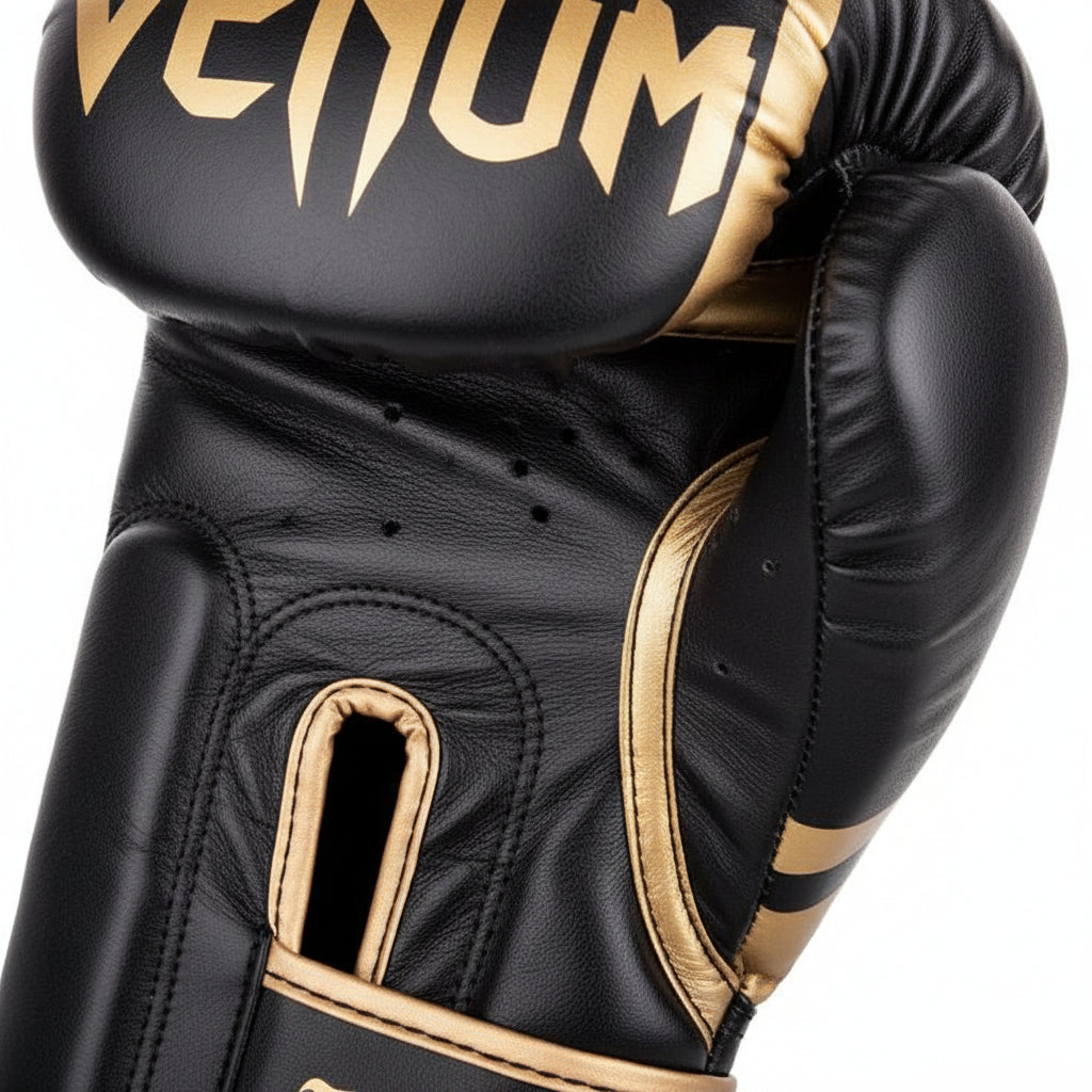 Black and gold boxing gloves with Venum branding on a white background