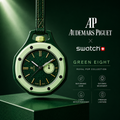 Green watch with Audemars Piguet and Swatch branding on a dark background