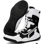 Black and white high-top sneakers with a detailed sole on a white background