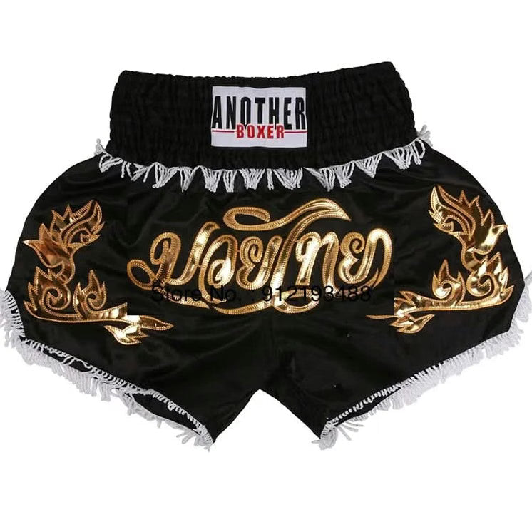 Black and gold boxing shorts with decorative patterns on a white background