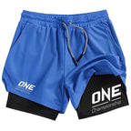 Blue athletic shorts with a black inner layer visible at the hem, featuring white 'ONE Championship' logos on the left leg and right leg, with a gray and white drawstring.
