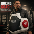 Man wearing a boxing coach body protector with Iron Jar branding in a boxing ring setting.