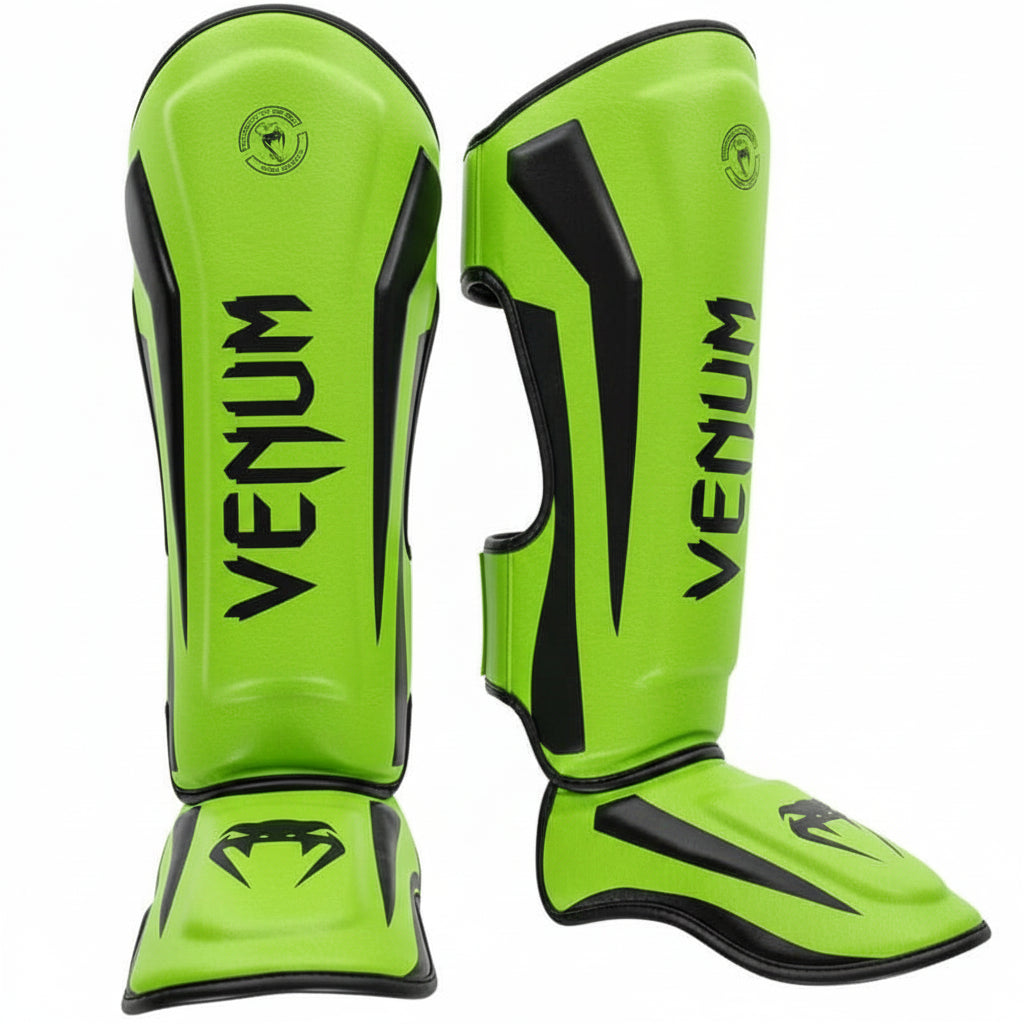 Bright green Venum shin guards on a gray background