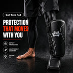 Person wearing a black calf kick pad with branding on a dark background