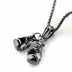 Silver boxing glove pendant on a chain against a white background