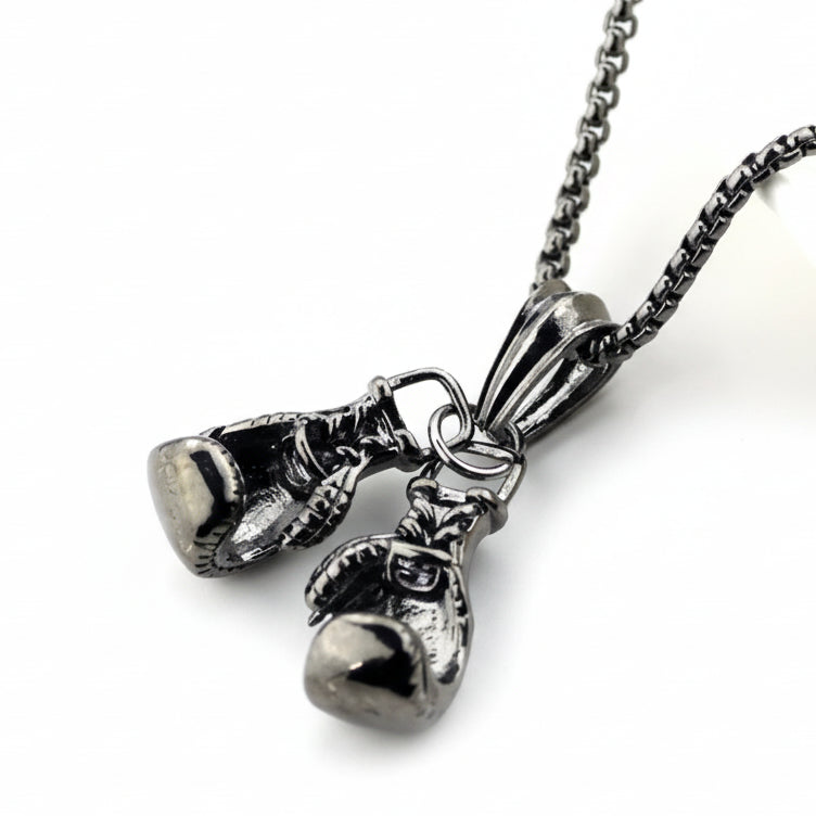 Silver boxing glove pendant on a chain against a white background