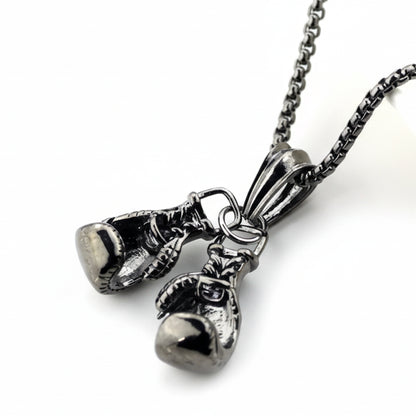 Silver boxing glove pendant on a chain against a white background