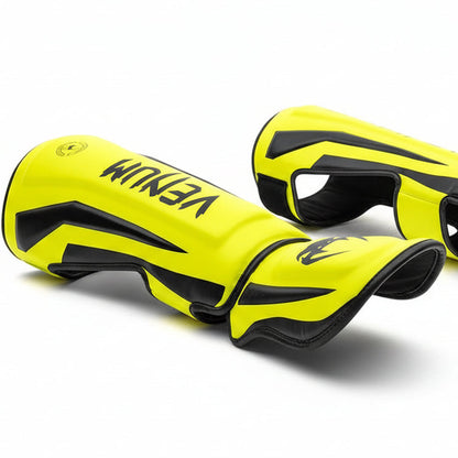 Pair of yellow and black knee pads with 'YEMI' branding on a white background