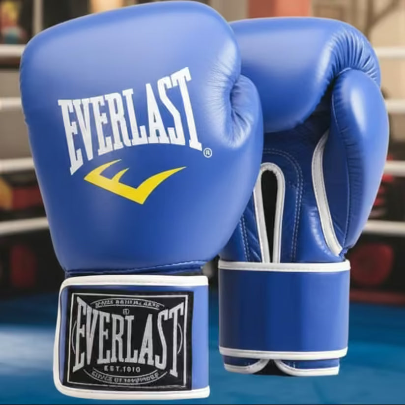 A pair of blue Everlast boxing gloves with white and yellow branding, shown against a blurred boxing ring background.