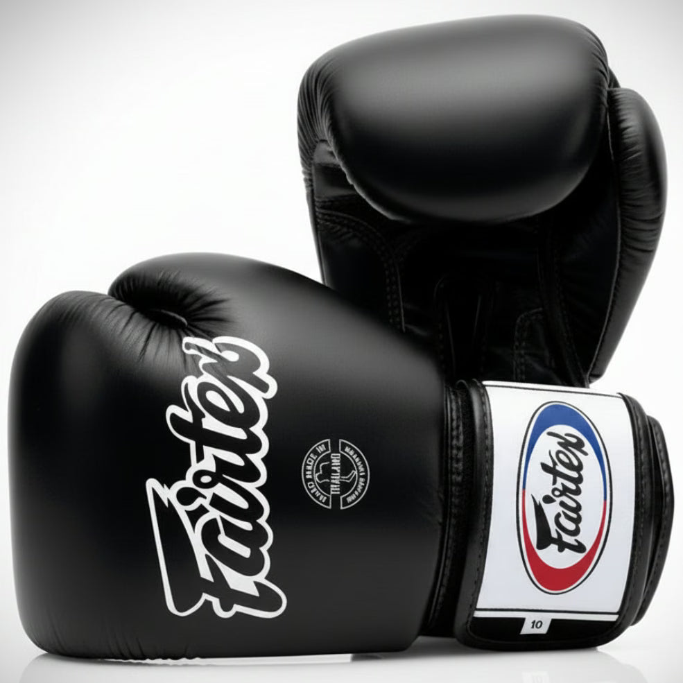 Black boxing gloves with Fairtex branding on a white background