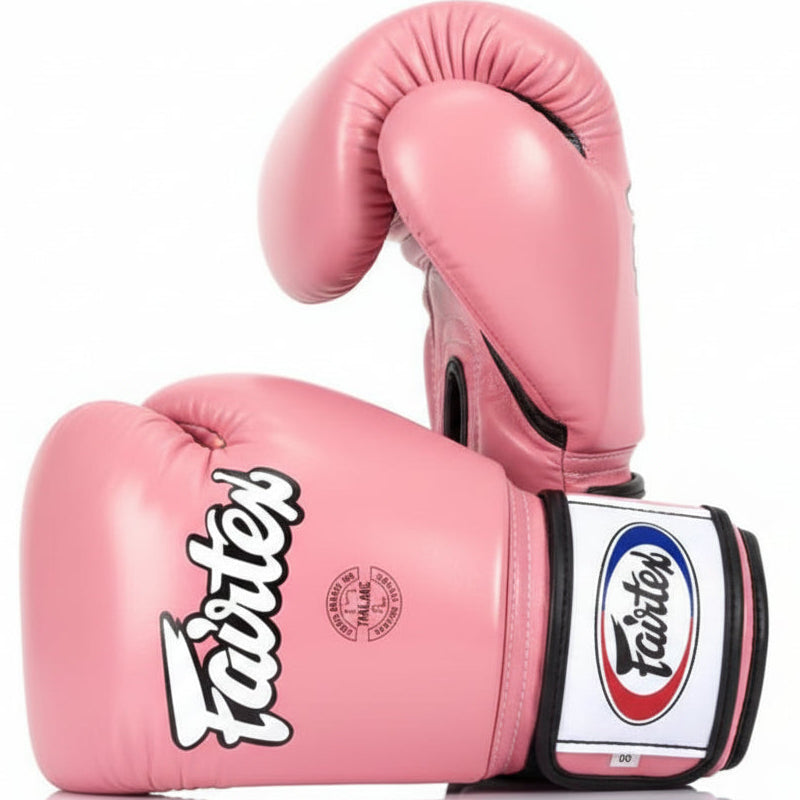 Pink boxing gloves with Fairtex logo on a white background