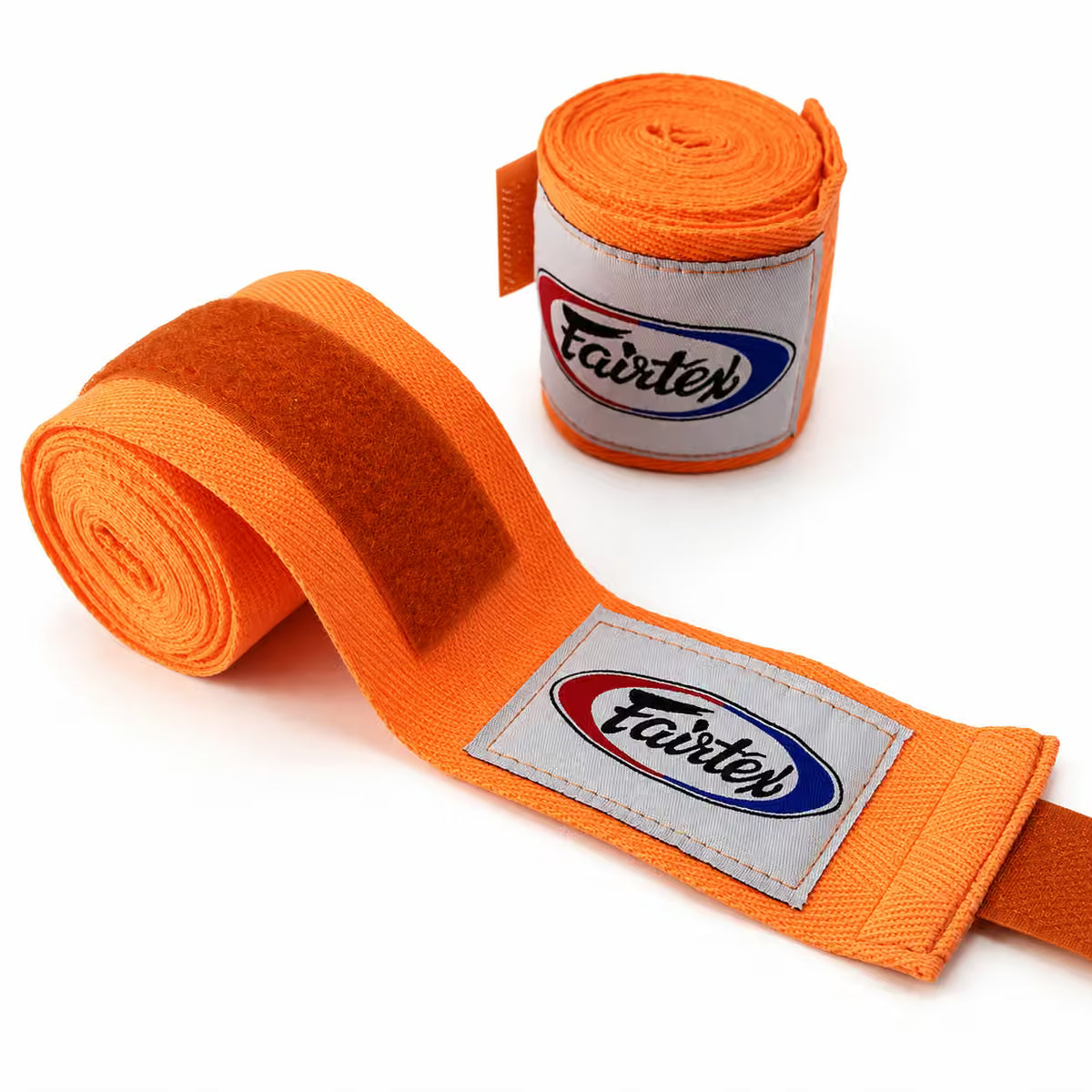 Bright orange Fairter hand wraps, with one rolled up and one laid out to show the strap and logo patch, on a clean white background.