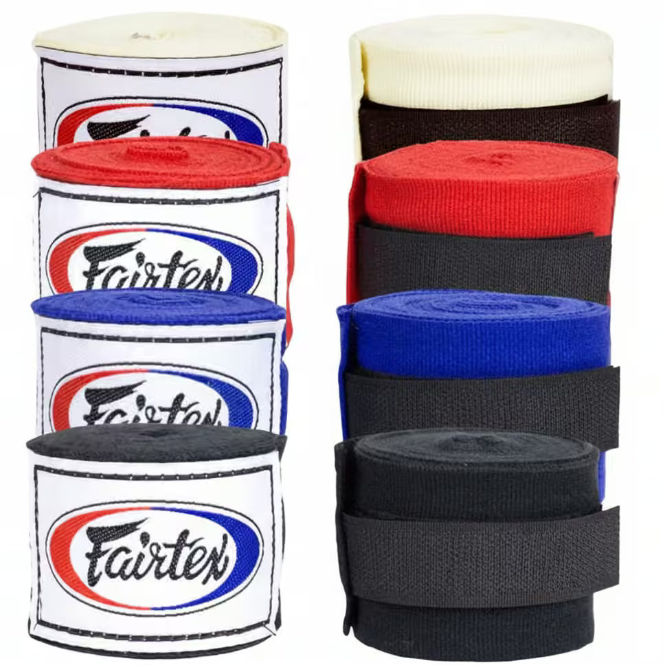 Eight rolls of Fairtex hand wraps arranged in two columns of four, showing the available color options: cream, red, blue, and black, with the Fairtex logo clearly visible on each roll.
