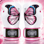 A pair of white boxing gloves featuring large pink, black, and blue butterfly designs on the front, with pink trim and a black GINGPA brand patch on the wrist straps, set against a pink sparkling background.