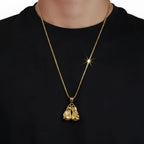 Person wearing a gold chain with boxing gloves hanging on chain