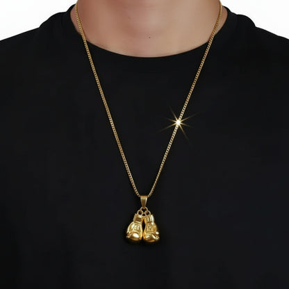Person wearing a gold chain with boxing gloves hanging on chain