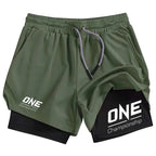 Olive green and black double-layer athletic shorts with 'ONE Championship' branding, displayed on a clean white background.