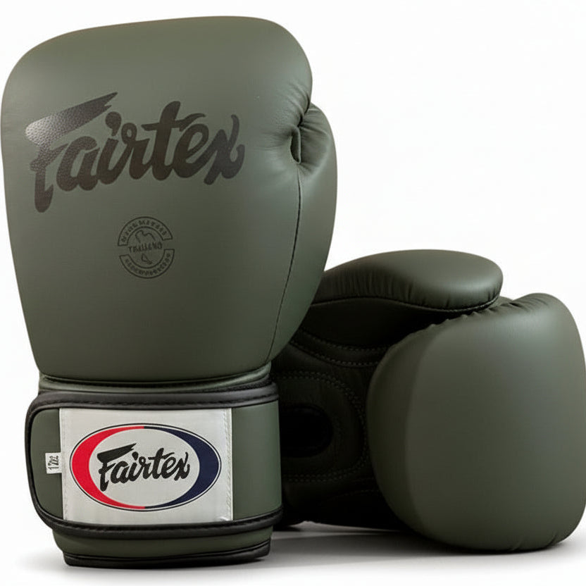 Pair of green Fairtex boxing gloves on a white background