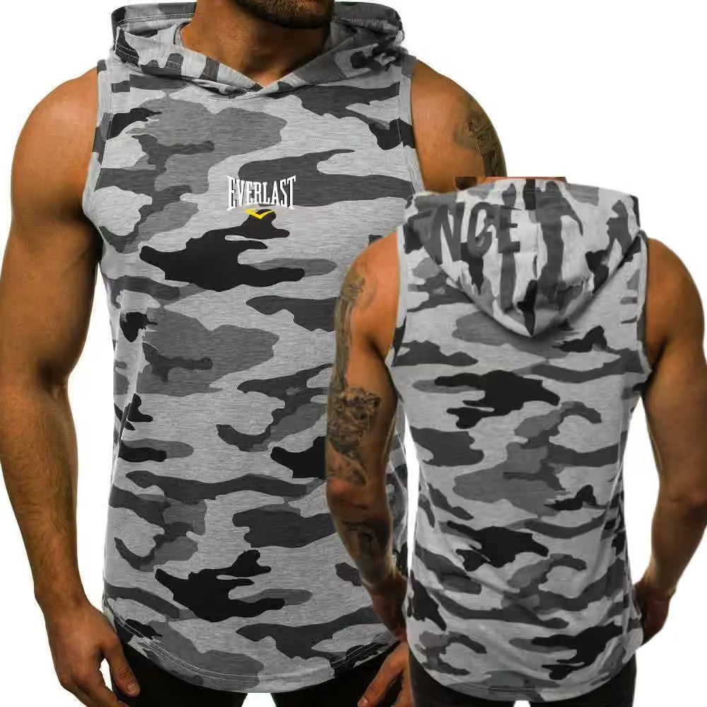 A sleeveless hooded muscle shirt with a gray, black, and white camouflage pattern, shown on a model from both the front and back views. The front features a white 'Everlast' logo with a small yellow accent, and the back displays the word 'ANCE' in white block letters.