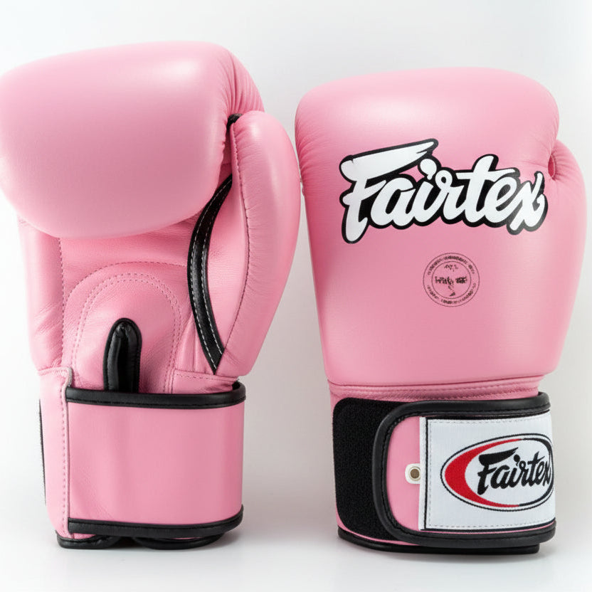 Pink boxing gloves with 'Fairtex' branding on a white background