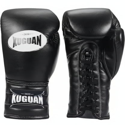 Black boxing gloves with Kuguan branding on a light wooden floor.