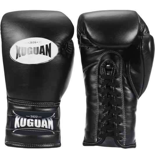 Black boxing gloves with Kuguan branding on a light wooden floor.