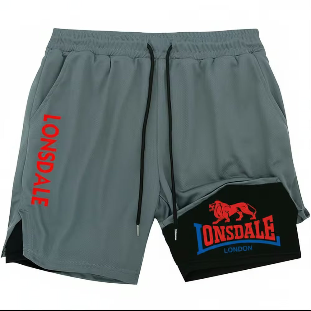 Gray athletic shorts with black side slits, black drawstrings, and bold red and blue Lonsdale branding on the left leg and right knee area.