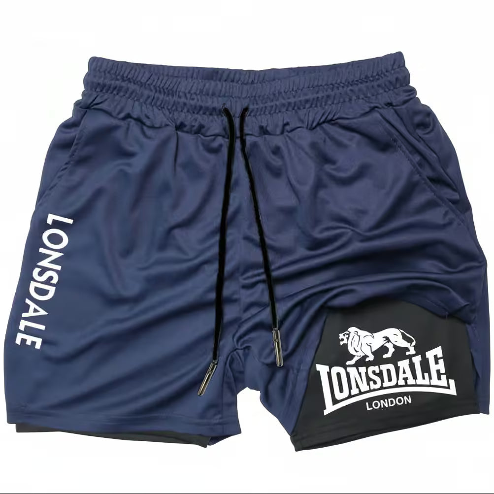 Navy blue athletic shorts with black drawstrings, featuring 'LONSDALE' printed in white on the left leg and a black patch on the right leg with the Lonsdale London lion logo.