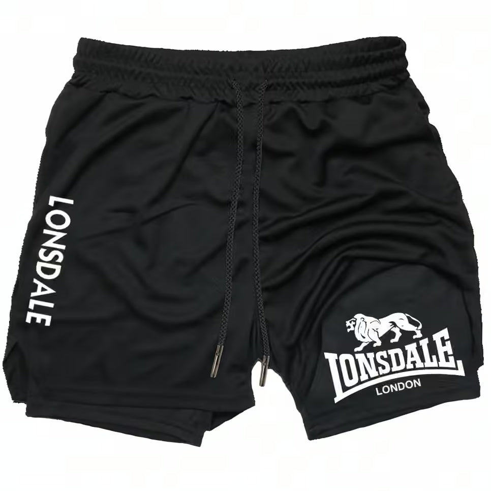 Black athletic shorts with white Lonsdale branding, featuring a drawstring waist and a lion graphic on the left leg, shown against a plain white background.